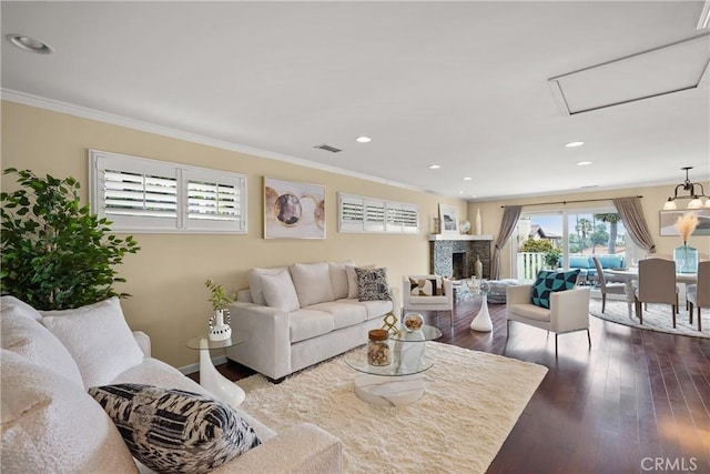 living area with visible vents, ornamental molding, recessed lighting, a fireplace, and dark wood-style flooring