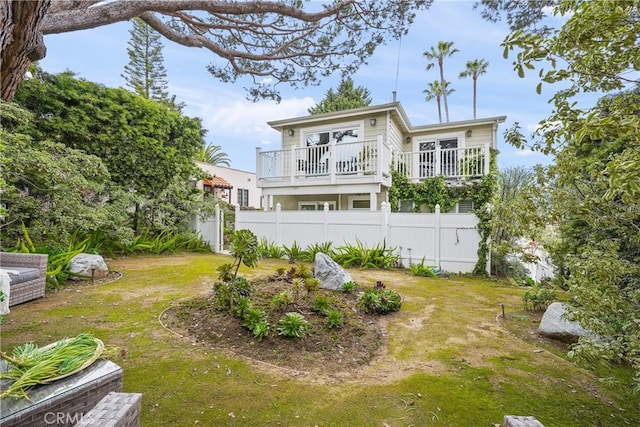 exterior space featuring fence and a lawn