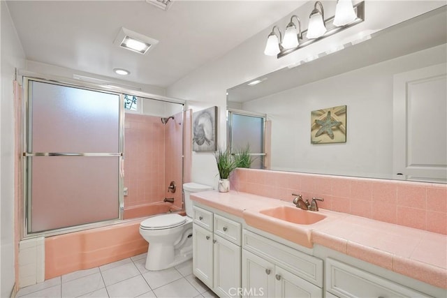 full bathroom with tile patterned floors, toilet, tasteful backsplash, bath / shower combo with glass door, and vanity