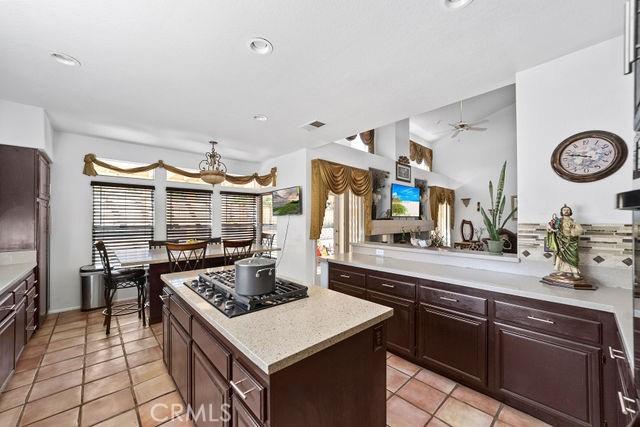 kitchen with recessed lighting, light countertops, visible vents, a kitchen island, and gas cooktop