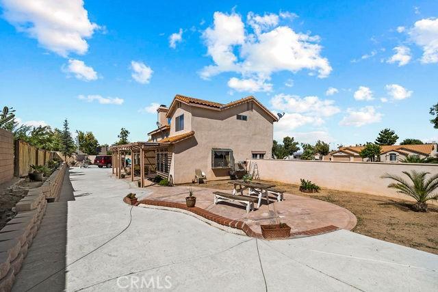 back of house with a pergola, a fenced backyard, a patio, and stucco siding