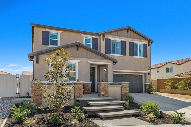 craftsman inspired home featuring a garage, concrete driveway, stone siding, fence, and board and batten siding