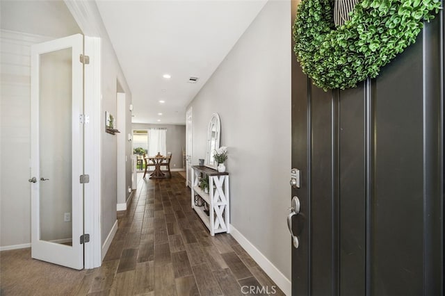 entrance foyer featuring visible vents, baseboards, dark wood-style flooring, and recessed lighting