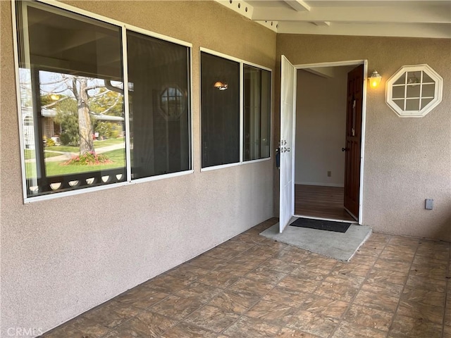 view of exterior entry with stucco siding