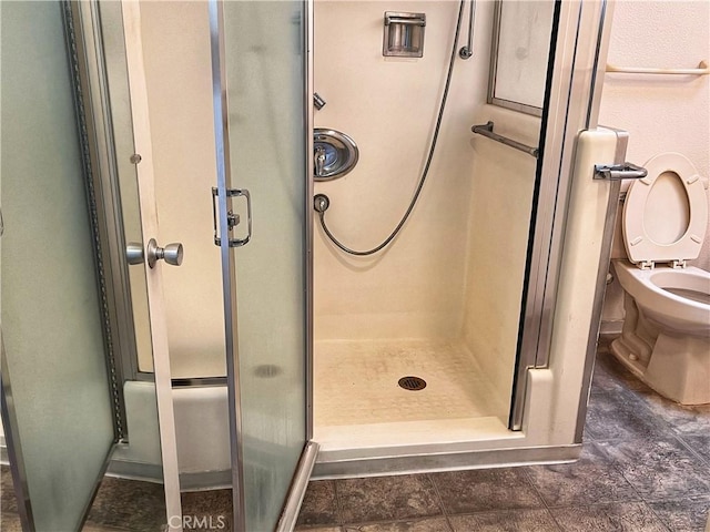 full bath with a shower stall and toilet