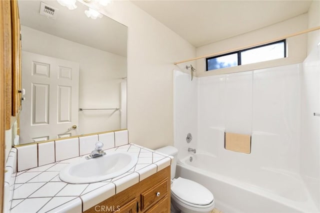 bathroom with shower / washtub combination, visible vents, vanity, and toilet