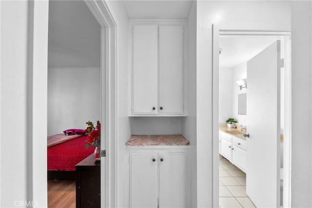 interior space with tile patterned flooring, vanity, and ensuite bathroom