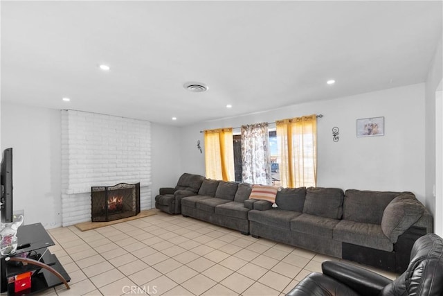 living area featuring light tile patterned flooring, a fireplace, visible vents, and recessed lighting