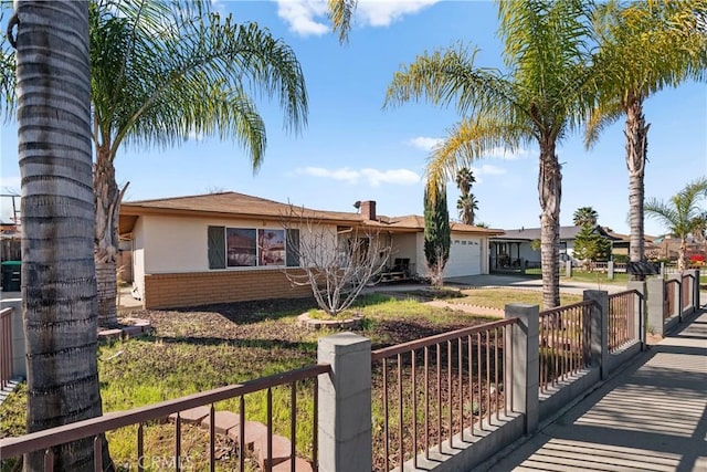 ranch-style home featuring an attached garage, stucco siding, concrete driveway, and brick siding