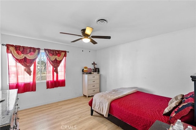 bedroom featuring ceiling fan, light wood-type flooring, and visible vents