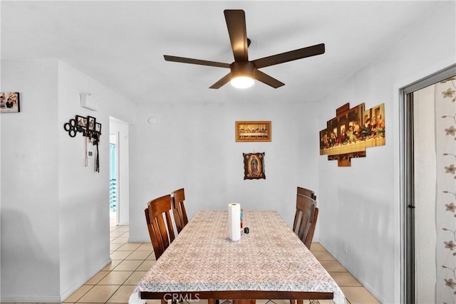 dining area featuring a ceiling fan and light tile patterned flooring