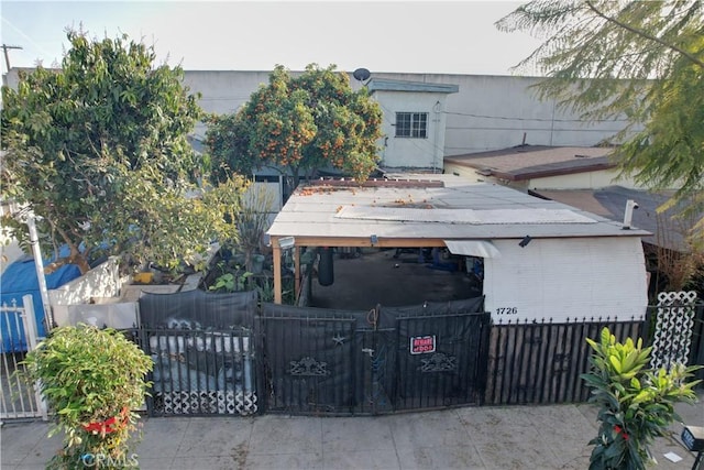 view of front of property with a fenced front yard and a gate