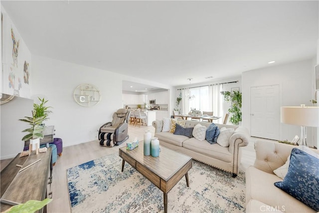 living area with wood finished floors and recessed lighting