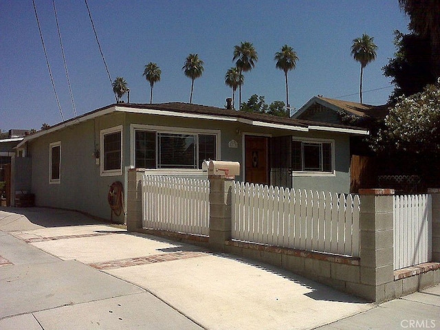 view of front of house with a fenced front yard and stucco siding