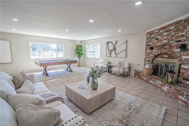 living area with recessed lighting, a brick fireplace, pool table, and light tile patterned floors