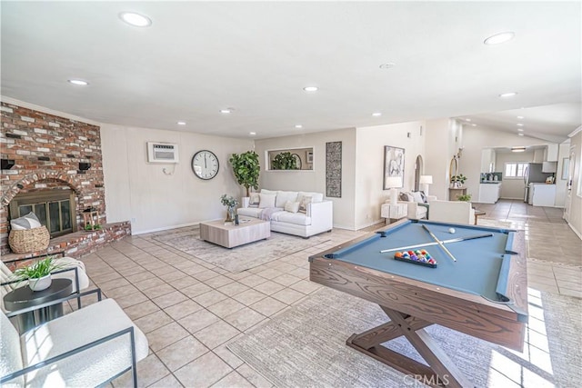 playroom with recessed lighting, vaulted ceiling, a fireplace, and light tile patterned floors