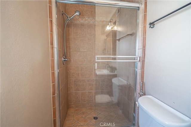 full bath with toilet and a stall shower