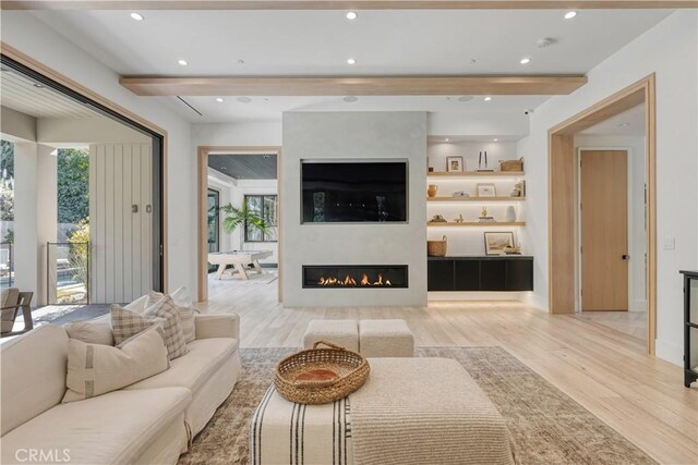 4050 Contera Rd, Encino, CA 91436 - living area featuring beam ceiling, wood finished floors, a glass covered fireplace, and recessed lighting