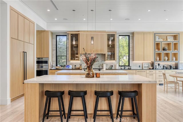4050 Contera Rd, Encino, CA 91436 - kitchen featuring modern cabinets, light brown cabinetry, a center island, healthy amount of natural light, and recessed lighting