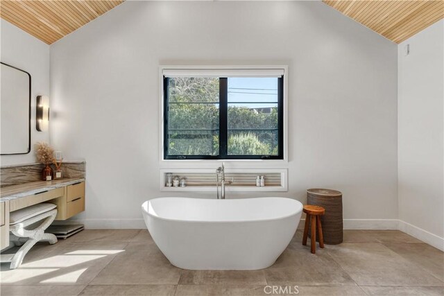 4050 Contera Rd, Encino, CA 91436 - bathroom with wooden ceiling, lofted ceiling, a freestanding tub, vanity, and baseboards