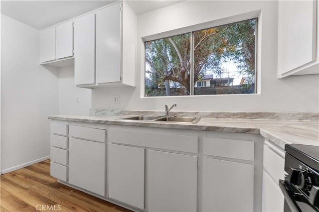 4738 Knoll Wood Ct, Oceanside, CA 92056 - kitchen featuring a sink, white cabinets, light wood-style flooring, and range
