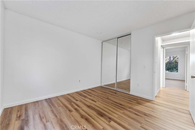 4738 Knoll Wood Ct, Oceanside, CA 92056 - unfurnished bedroom featuring light wood-type flooring, baseboards, and a closet
