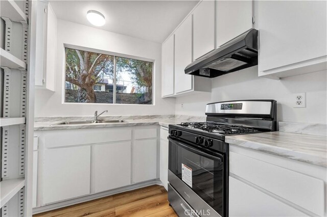 4738 Knoll Wood Ct, Oceanside, CA 92056 - kitchen with range with gas stovetop, under cabinet range hood, a sink, white cabinets, and light wood-type flooring