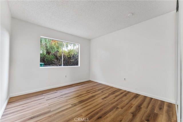 4738 Knoll Wood Ct, Oceanside, CA 92056 - unfurnished room featuring a textured ceiling, wood finished floors, and baseboards