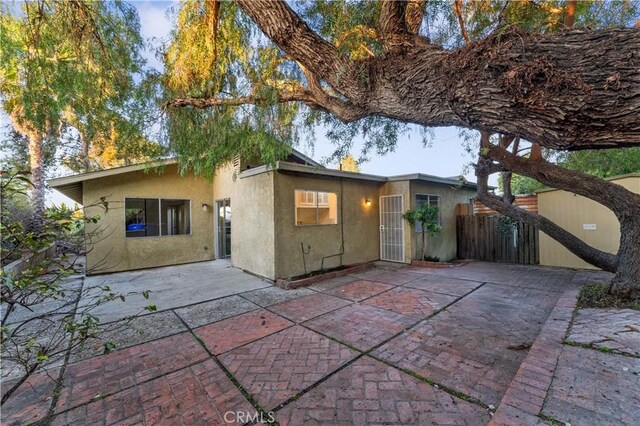 4738 Knoll Wood Ct, Oceanside, CA 92056 - back of house with stucco siding and a patio area