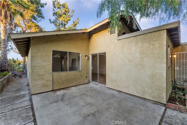 4738 Knoll Wood Ct, Oceanside, CA 92056 - rear view of house with stucco siding and a patio