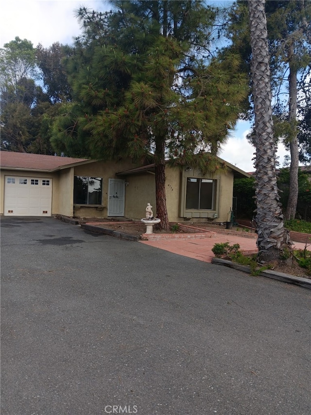 4738 Knoll Wood Ct, Oceanside, CA 92056 - view of front of home with an attached garage, stucco siding, and driveway