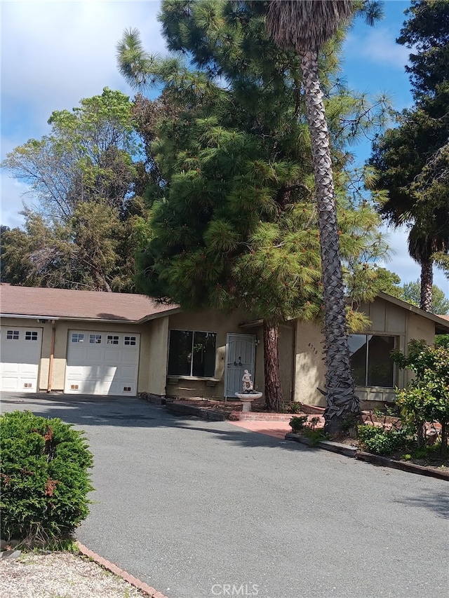 4738 Knoll Wood Ct, Oceanside, CA 92056 - view of front of property with stucco siding and driveway