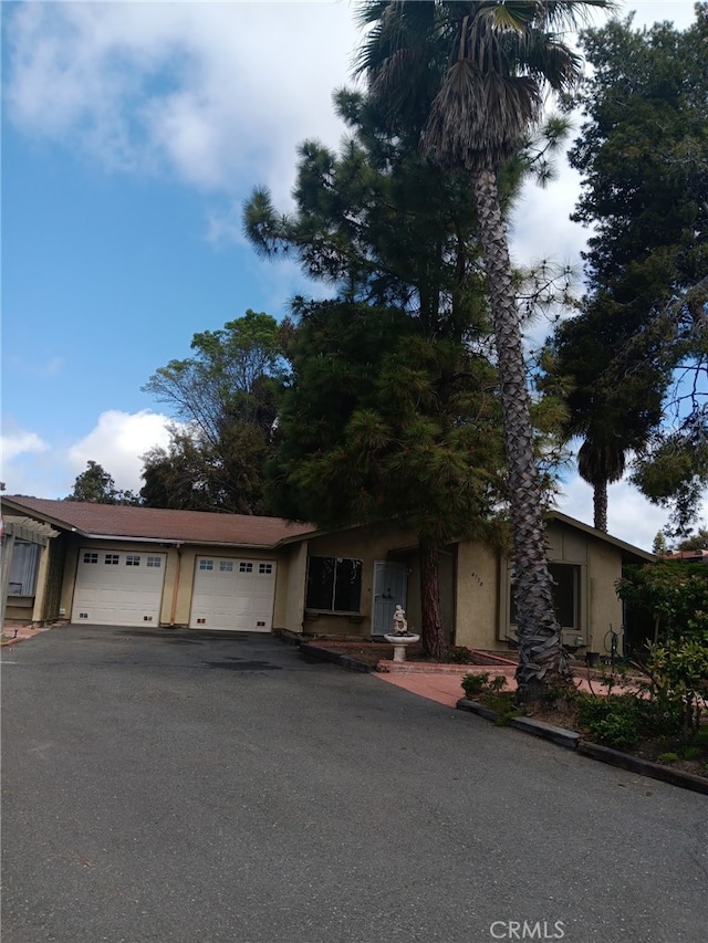 4738 Knoll Wood Ct, Oceanside, CA 92056 - view of front of home featuring asphalt driveway, stucco siding, and a garage
