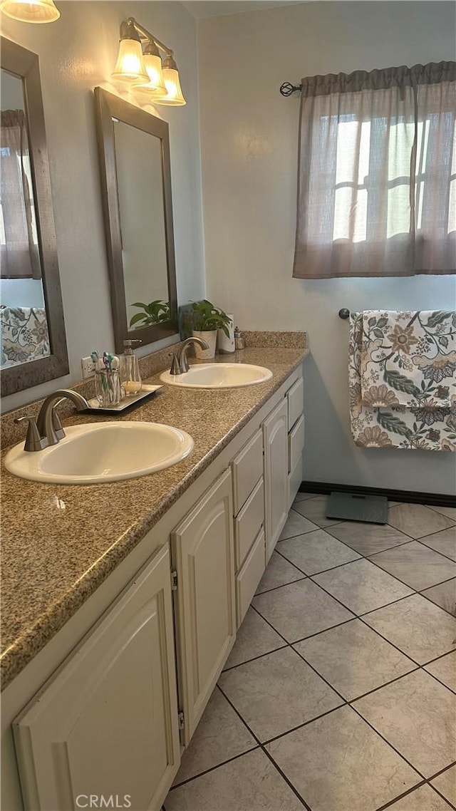 full bathroom with tile patterned flooring, a sink, and double vanity