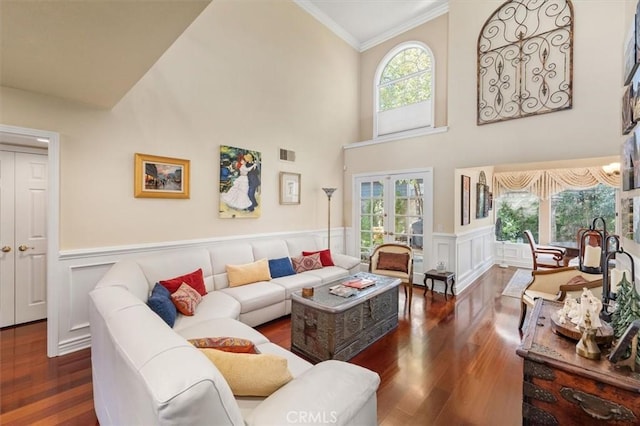 living room featuring french doors, plenty of natural light, and wood finished floors