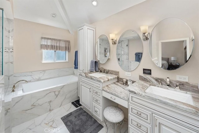 bathroom with marble finish floor, a garden tub, a sink, and double vanity