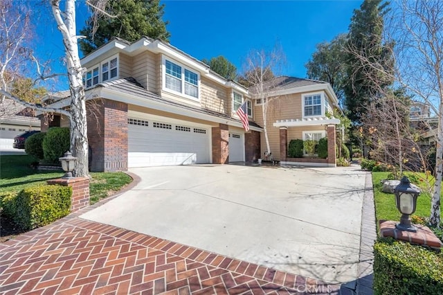 view of front of house with an attached garage, driveway, and brick siding