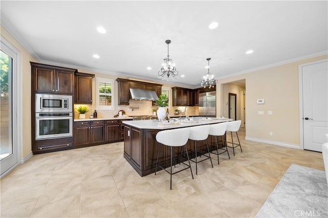 kitchen featuring built in appliances, light countertops, dark brown cabinetry, and under cabinet range hood