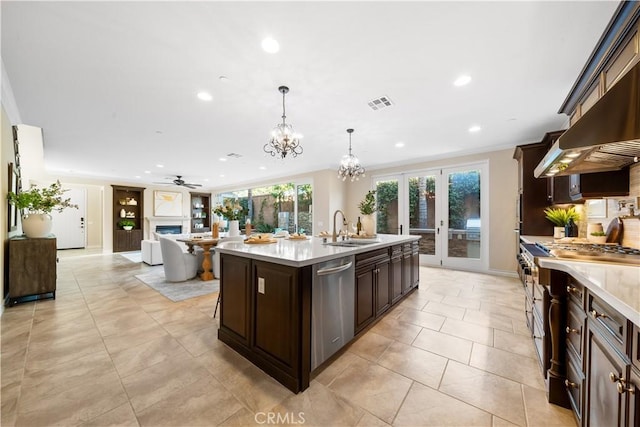 kitchen with dark brown cabinetry, stainless steel appliances, a sink, visible vents, and light countertops