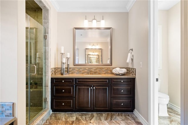 bathroom featuring marble finish floor, crown molding, toilet, a stall shower, and vanity