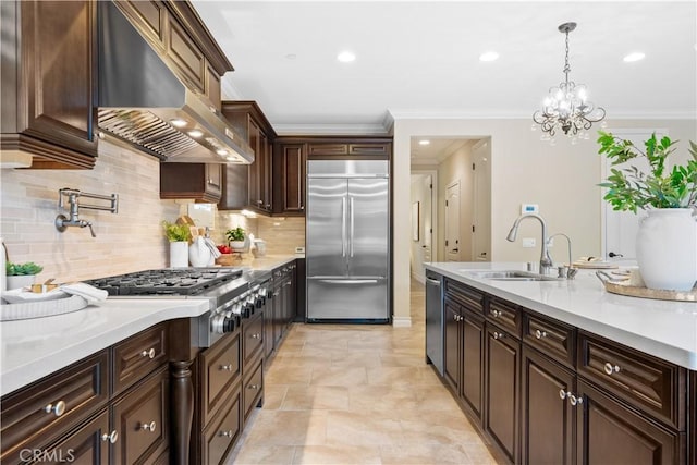 kitchen featuring a sink, exhaust hood, dark brown cabinets, appliances with stainless steel finishes, and decorative light fixtures