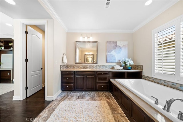 full bathroom with visible vents, crown molding, vanity, and a garden tub