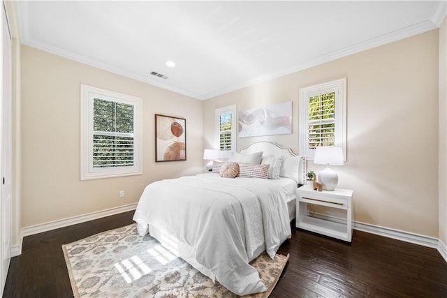 bedroom with dark wood-style floors, recessed lighting, visible vents, ornamental molding, and baseboards