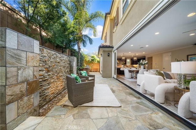 view of patio featuring fence and an outdoor living space