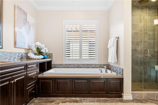 bathroom featuring a stall shower, a garden tub, vanity, and crown molding