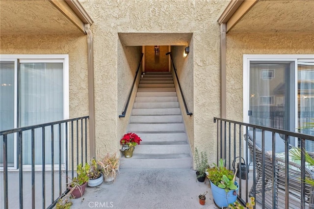 view of exterior entry with stucco siding