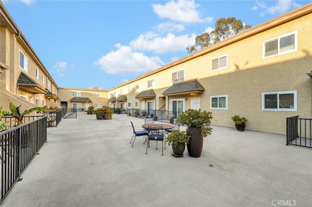 view of home's community featuring a residential view, a patio area, and fence