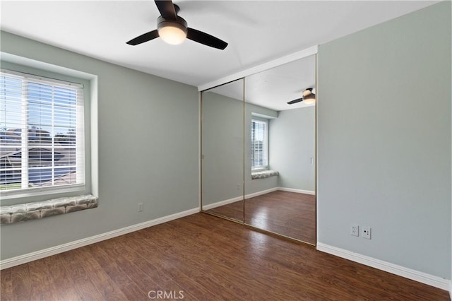 interior space featuring wood finished floors, a ceiling fan, and baseboards