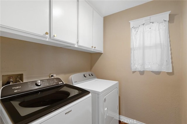 laundry room with washing machine and dryer and cabinet space