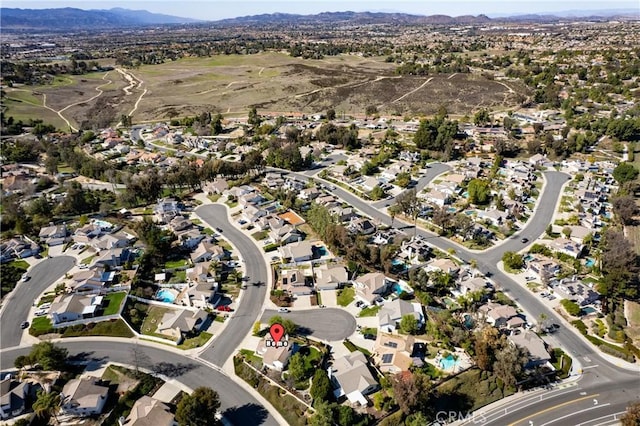 drone / aerial view featuring a residential view and a mountain view